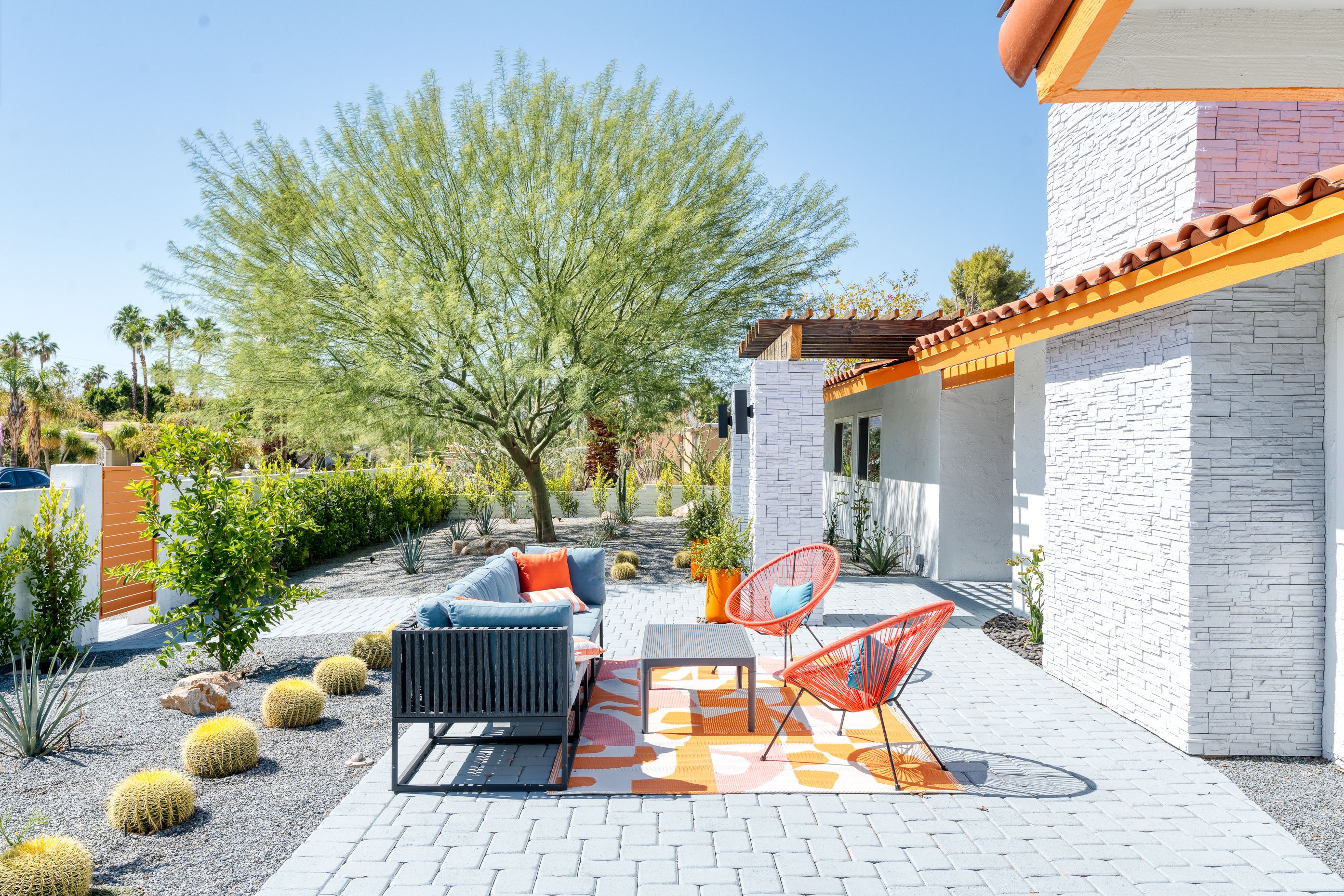 Sunny front courtyard with orange lounge chairs