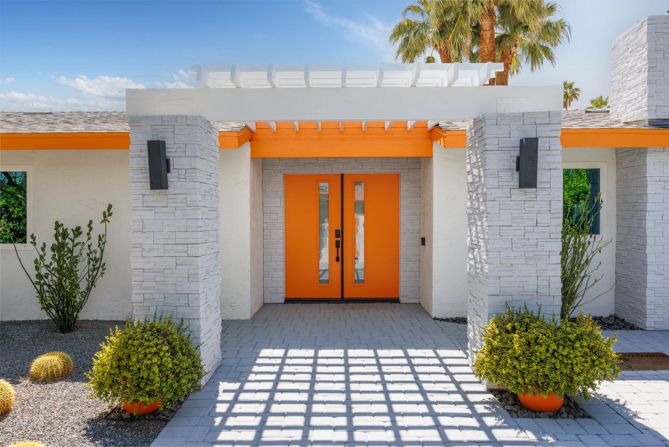 The Orchid House orange front doors and desert landscaping