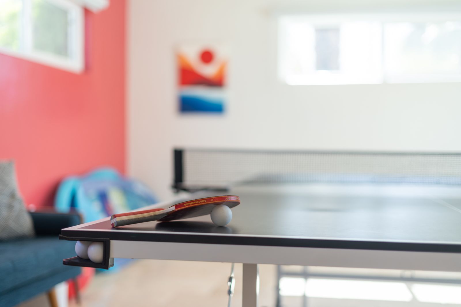 Close-up of a ping-pong paddle and ball on the game-room table