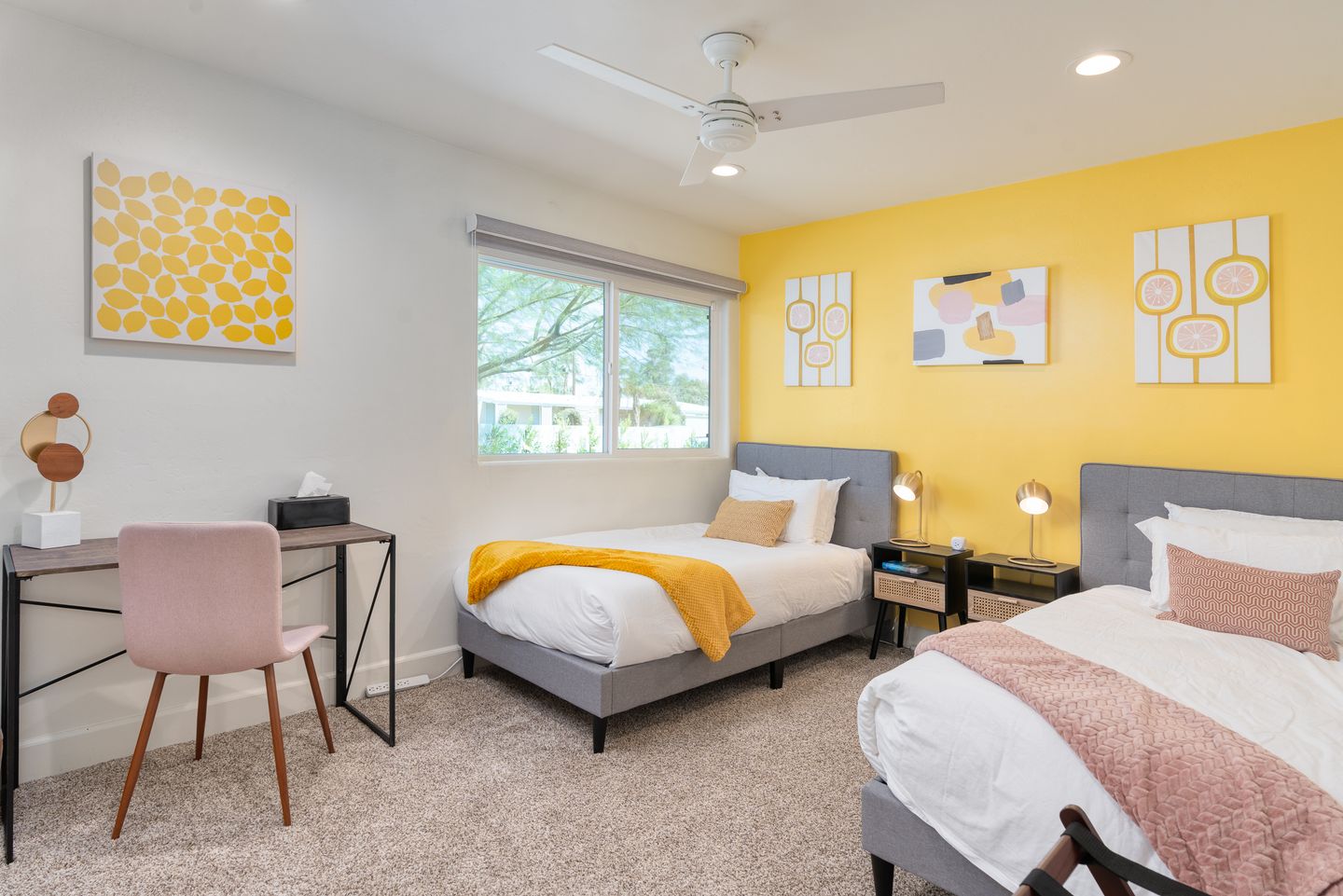 Angled view of the Lemon Bedroom twin beds and small desk