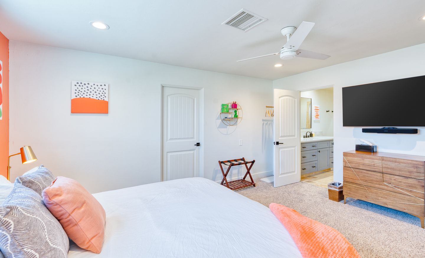 Watermelon Bedroom viewed from the bed toward the television and dresser