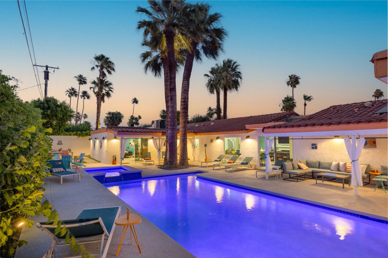 The Orchid House pool glowing beneath tall palms at dusk