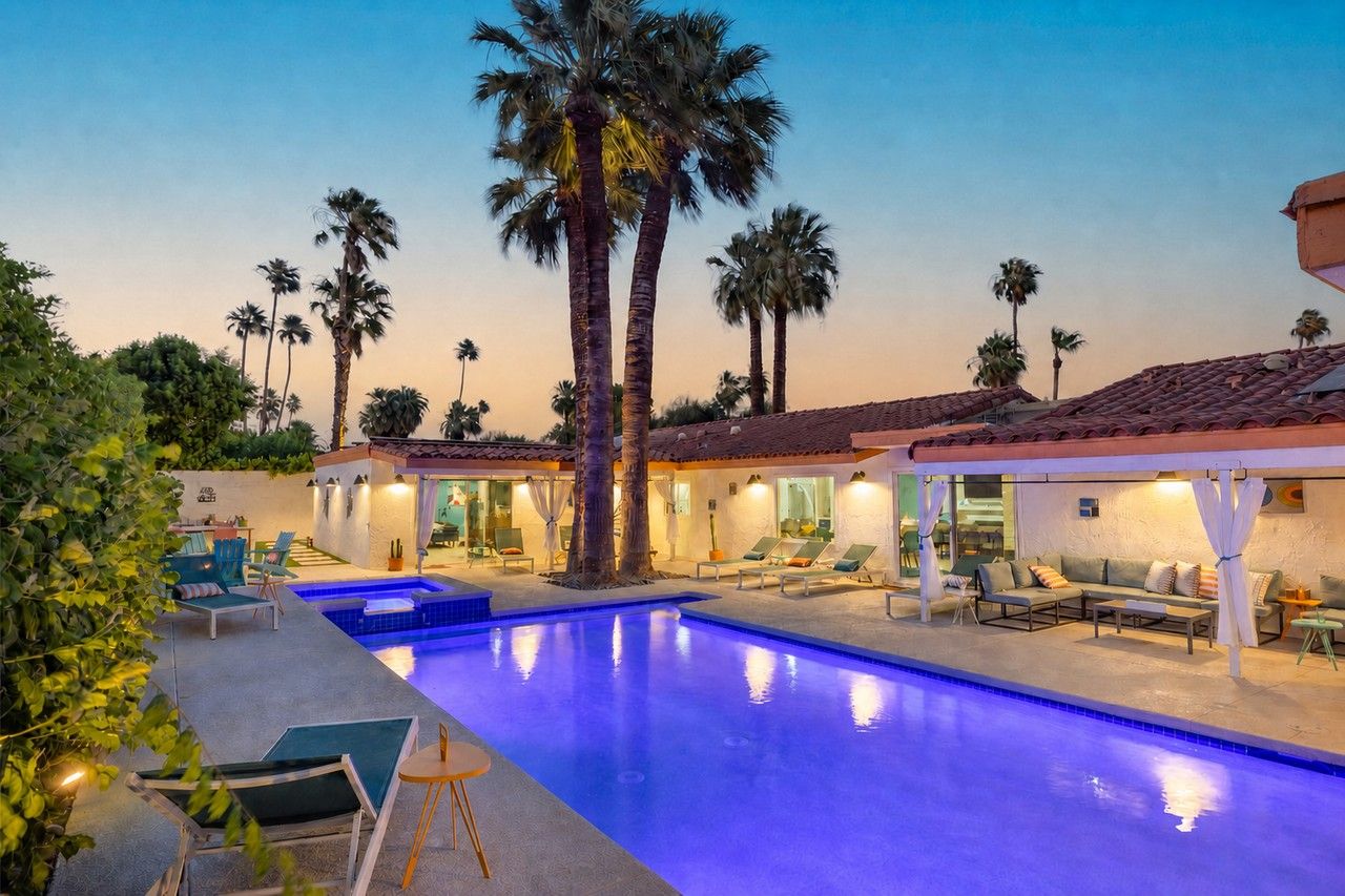 The Orchid House pool glowing beneath tall palms at dusk