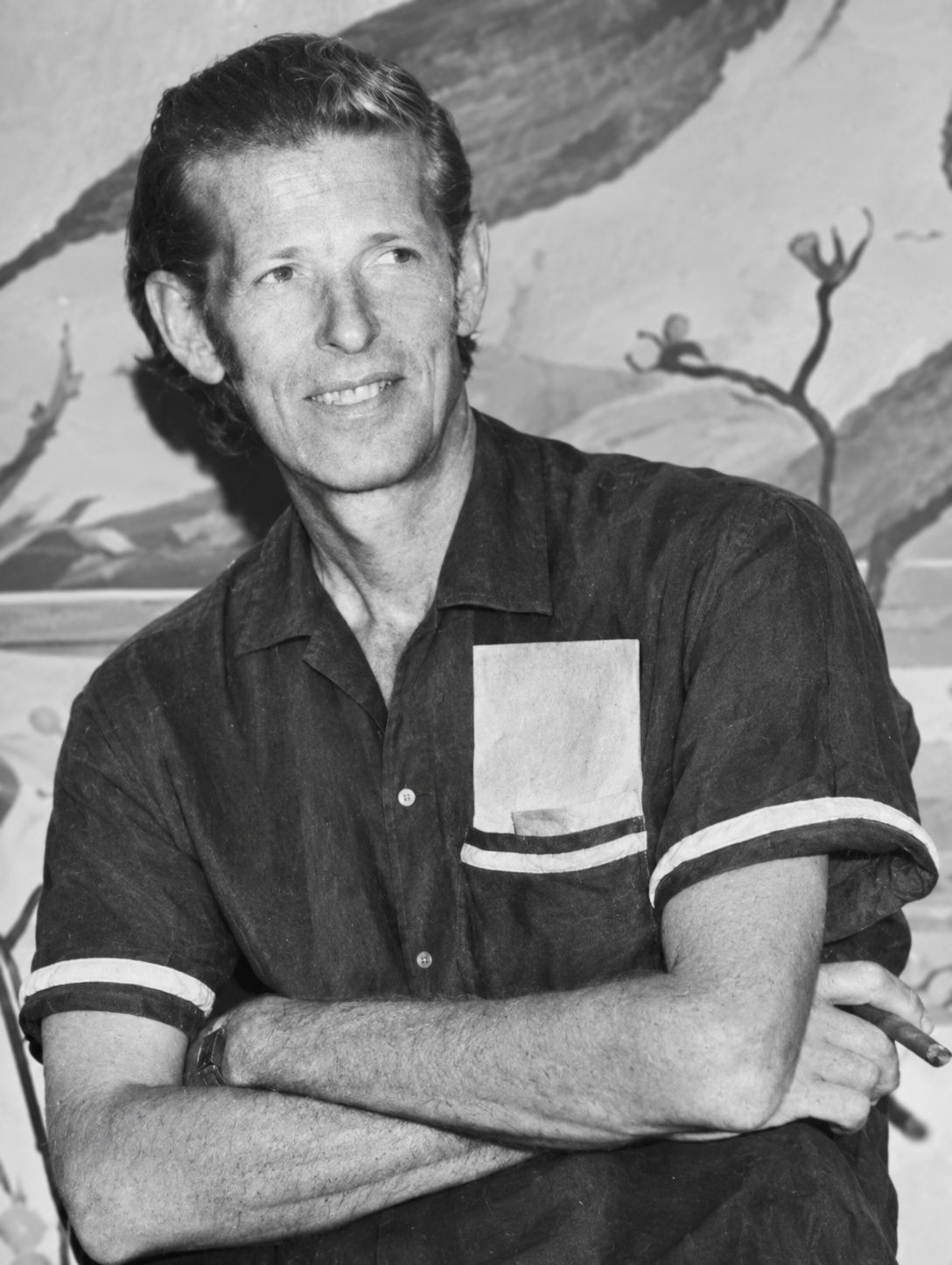 Black-and-white portrait of Howard P. Lapham seated with folded arms and holding a cigar