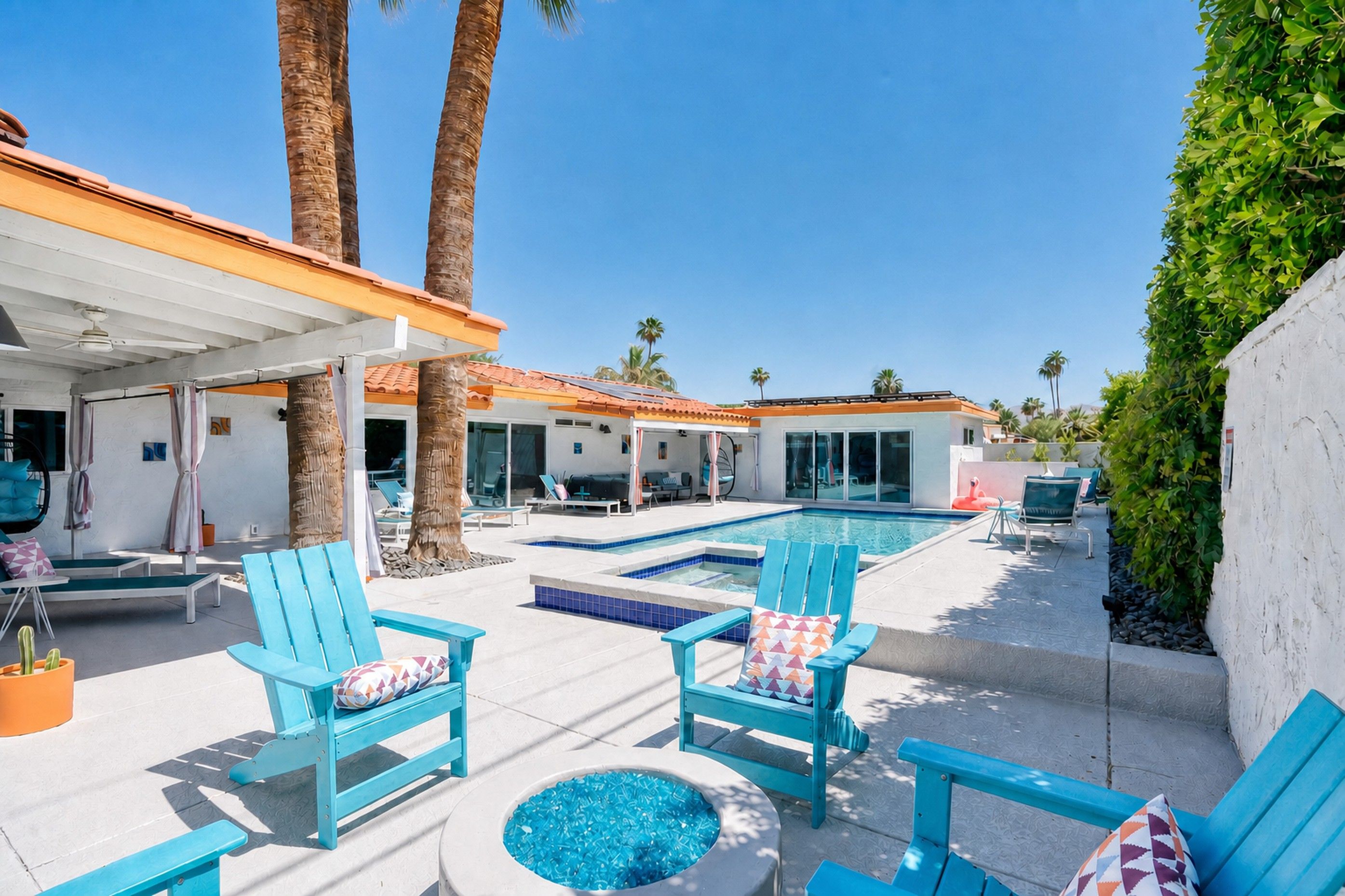 Private pool and raised spa framed by a colorful patio