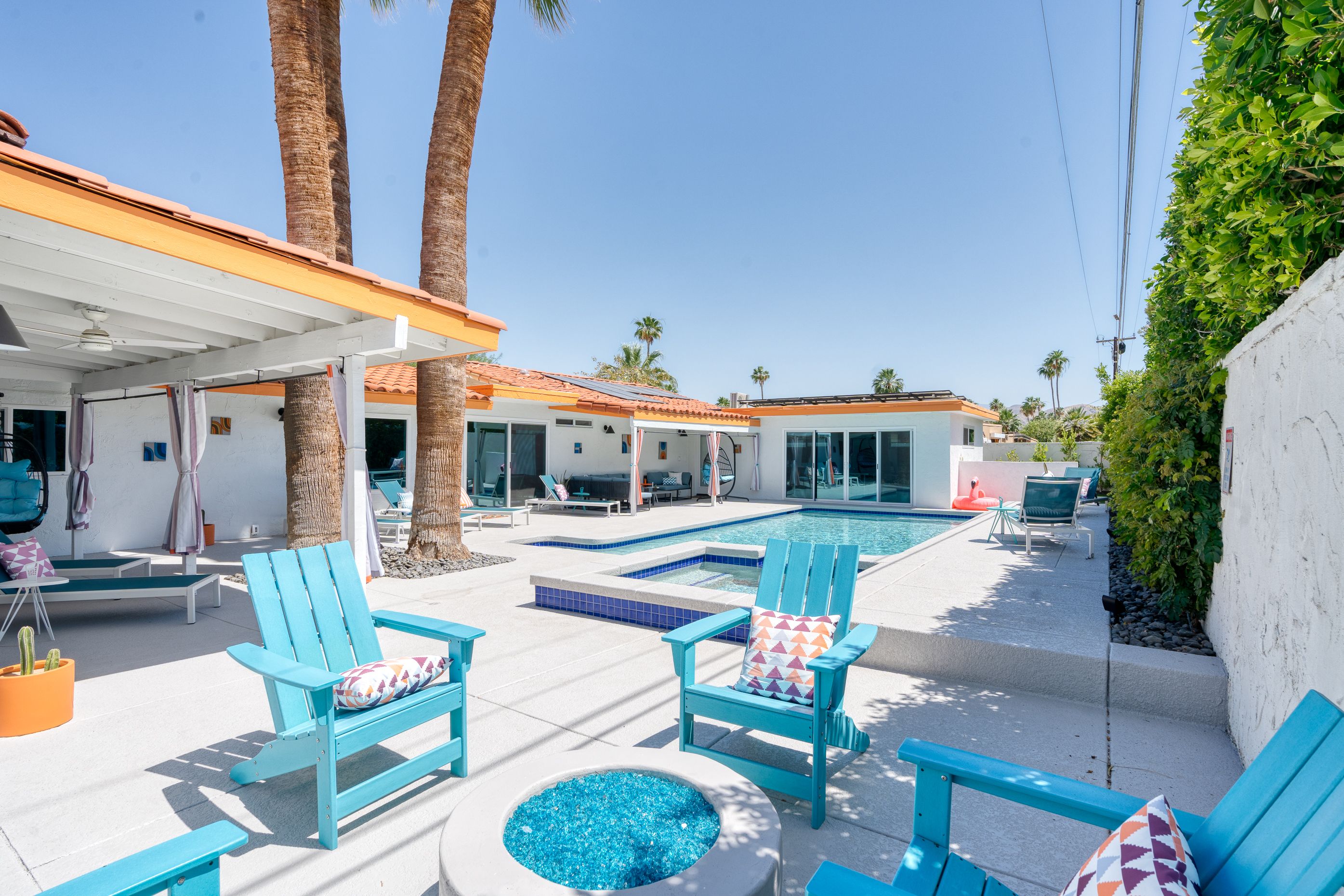 Private pool and raised spa framed by a colorful patio